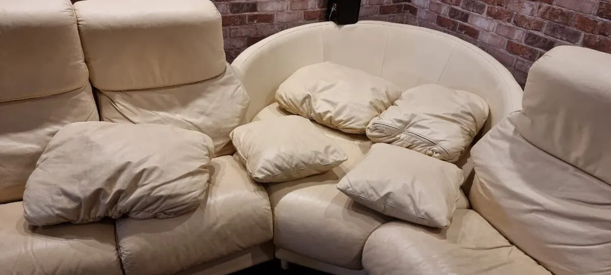 Worn sectional sofa before restoration