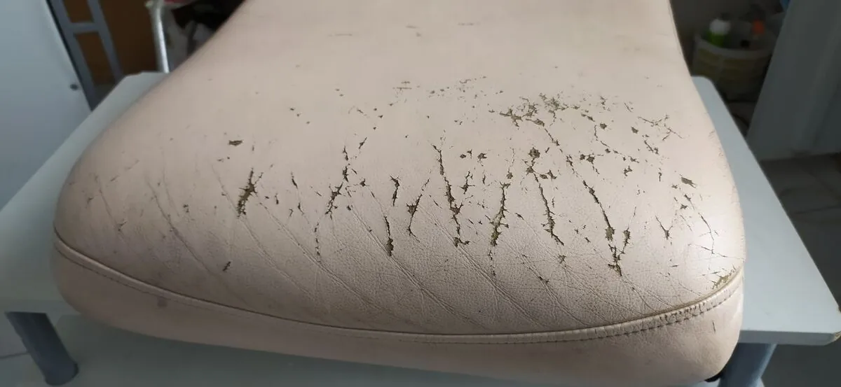 Cracked vinyl cushion before repair
